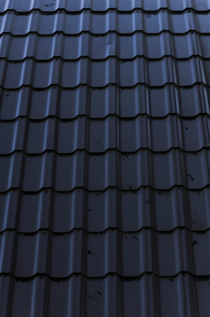 a close up of a metal roof with a sky background