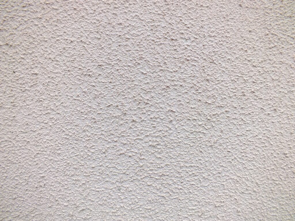 a close up of a white stucco wall elewacja